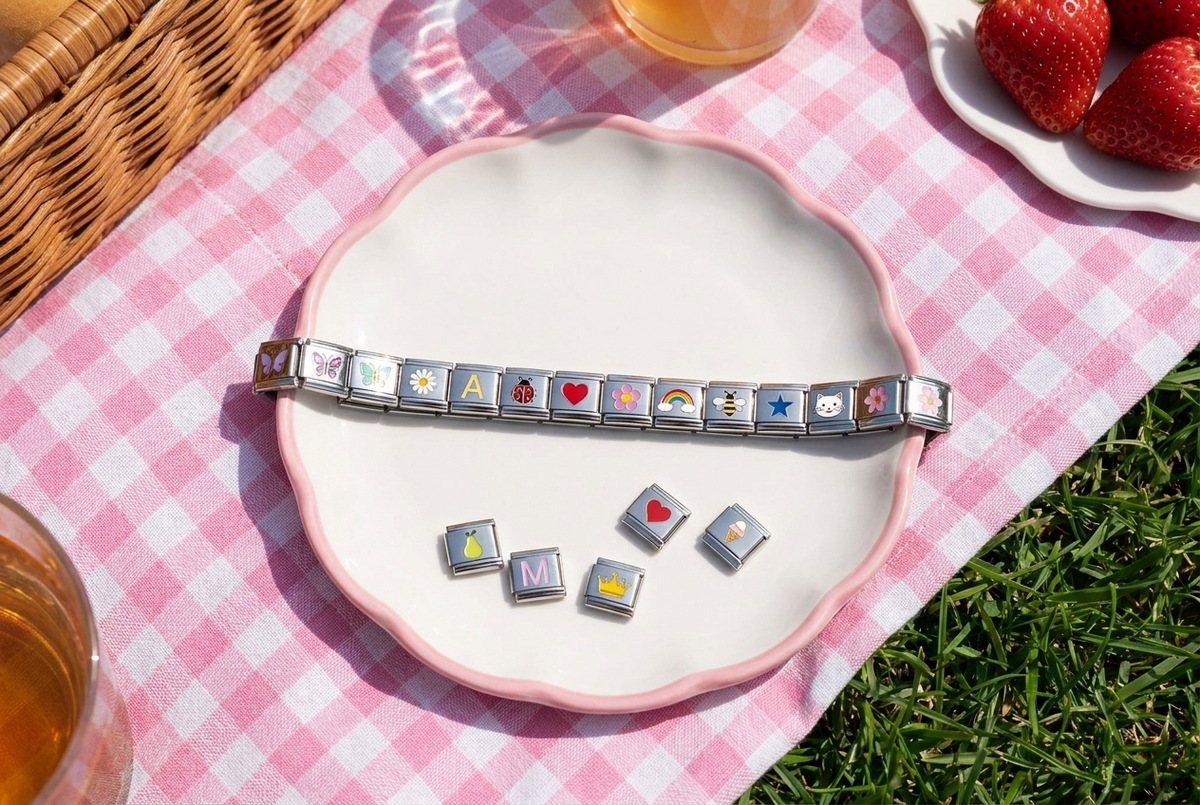 A charm bracelet and a few loose charms waiting to be picked, on a small plate